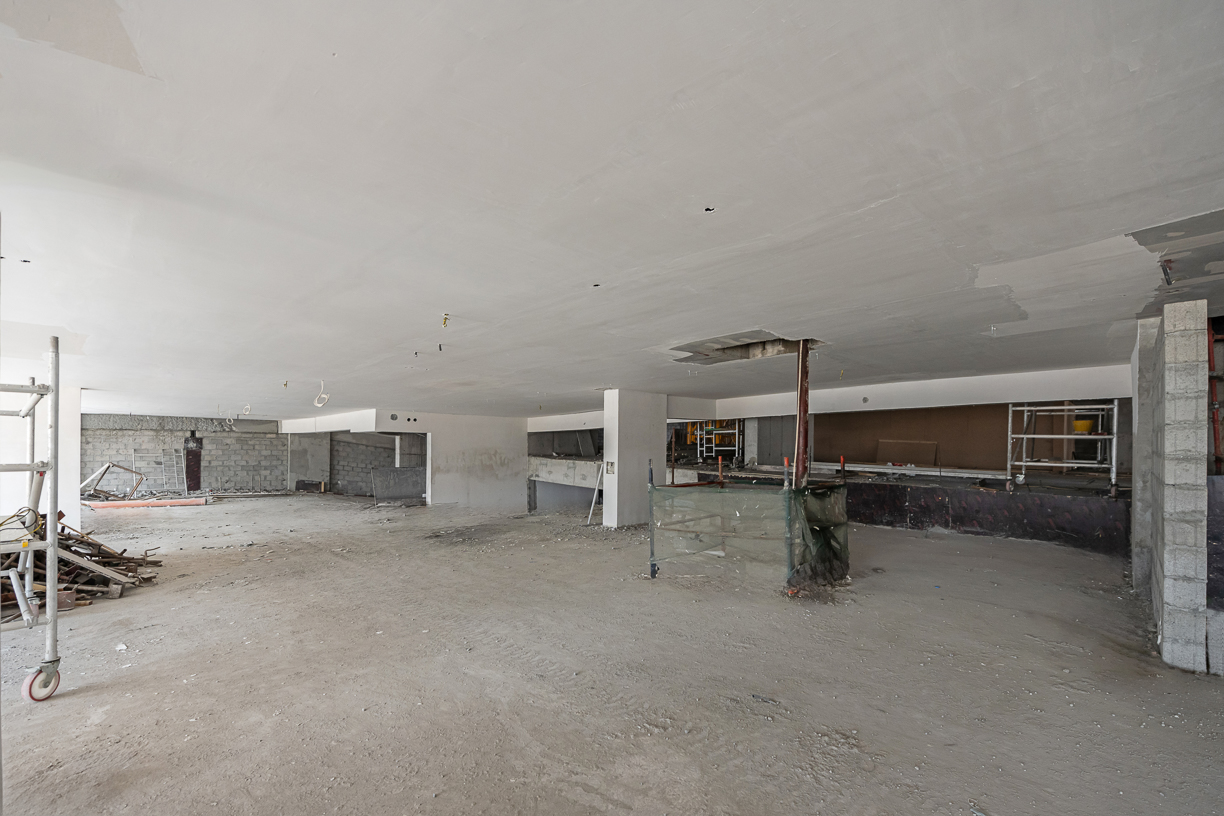 Pearl House By Imtiaz An unfinished interior space with bare walls, exposed ceiling, and construction materials scattered around.